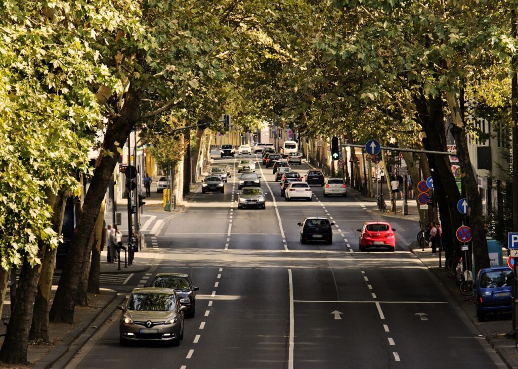 Autos circulando en una avenida urbana con tráfico (imagen ilustrativa)